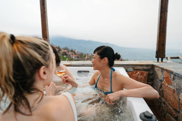 istock Smiling girlfriends in a hot tub 2185367945