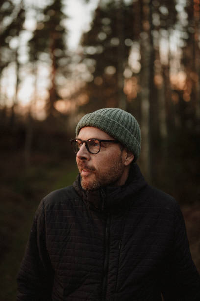 istock Man outdoors in forest at evening in winter 2185368129