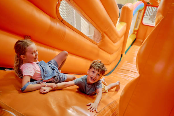 istock Cheerful children having fun on slide 2185368489