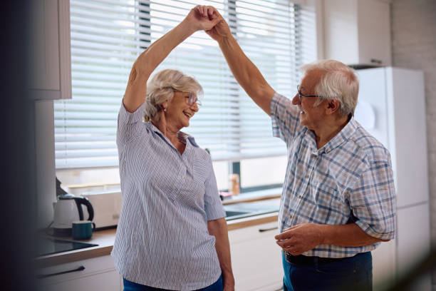 istock Carefree senior couple dancing in the kitchen. 2185369030