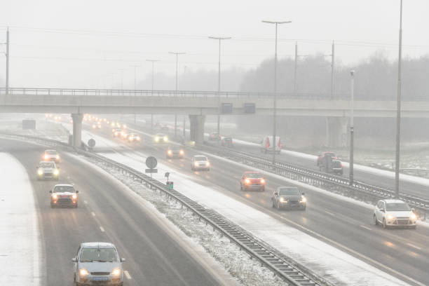 istock Moving traffic on a highway during a snow blizzard in winter 2185369883