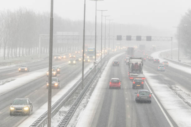 istock Moving traffic on a highway during a snow blizzard in winter 2185370309