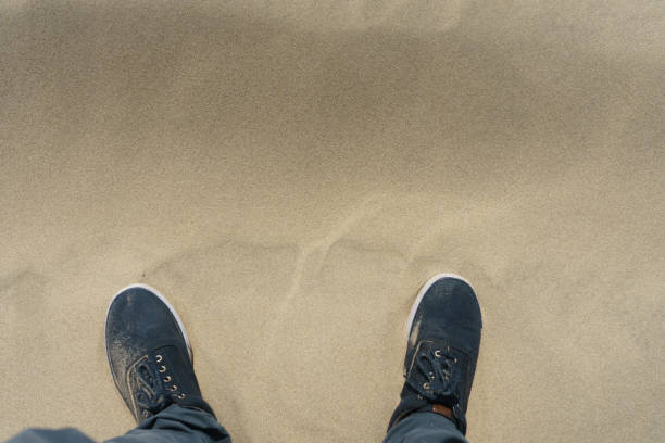 istock Shoes in the sand 2185370350