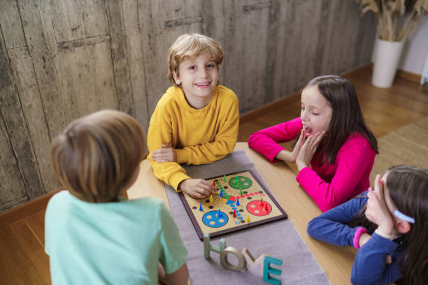 istock Group of children playing board game at home 2185370531