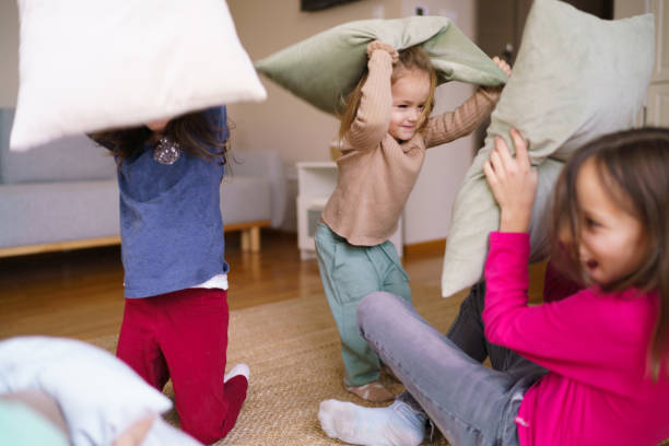 istock Children in a pillow fight game 2185371602