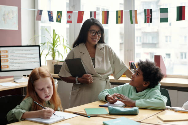 istock Schoolboy talking to young teacher 2185374059