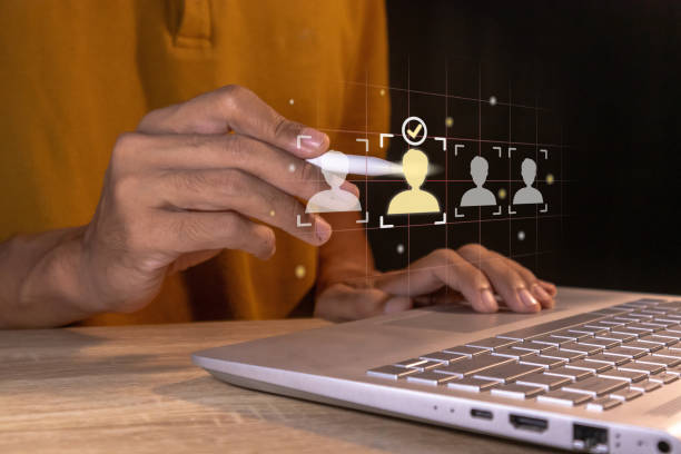 istock Man holding pen to select a person or candidate in a recruitment process on a virtual screen. Human resource or Career opportunity concept. 2185375365