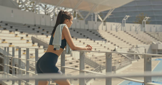 istock A female athlete taking a break after exercise at a stadium and thinking. Young woman looking thoughtful after playing sport outdoors 2185376374