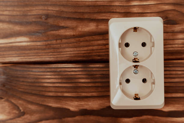 istock Electrical Outlet on Wooden Wall 2185377573