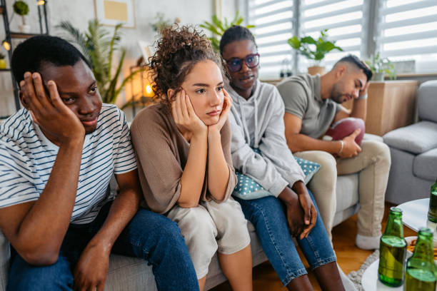 istock Group Of Friends Drinking Beer And Having Snacks While Watching A Rugby Game Together In The Living Room 2185377695