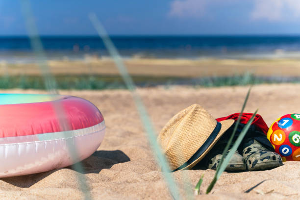 istock Beach toys and accessories on a sandy shore 2185379100