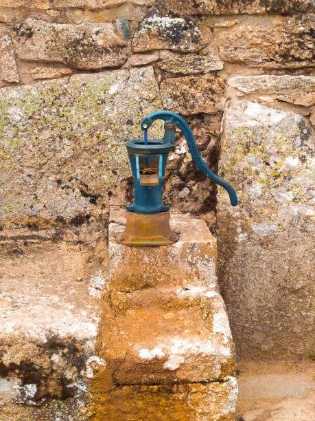 manual water fountain of a village manual water fountain, old iron fountain painted electric blue, located in a rural town in the province of Zamora, Spain old fashioned well hand pump stock pictures, royalty-free photos & images