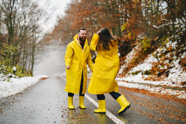 istock Lovely Couple in Waterproof Clothing Exploring the Forest While It's Raining and Smiling 2185380837