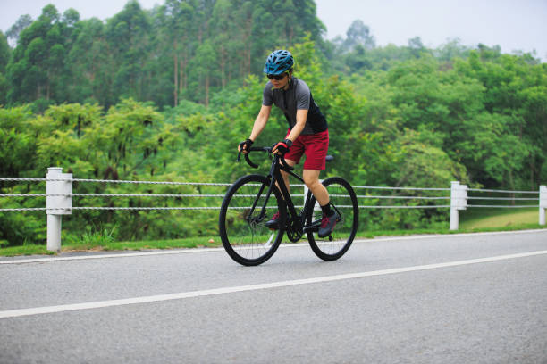 istock Asian woman cycling on summer trail 2185380904