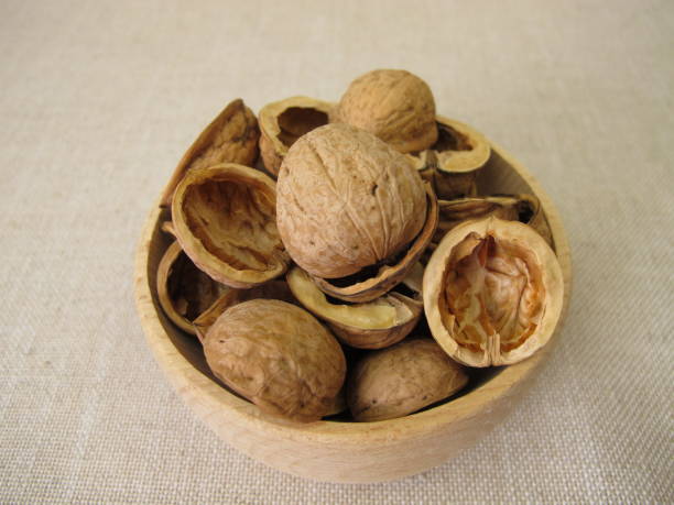 istock Craft material made from halved walnut shells in a wooden bowl 2185381062