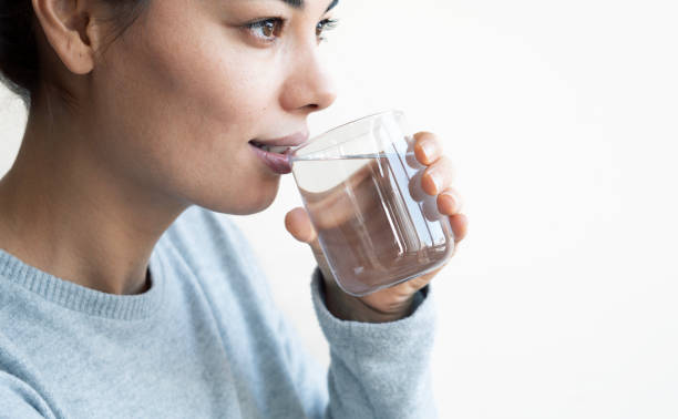 istock Water concept, Woman Drinking Water on white background 2185382983