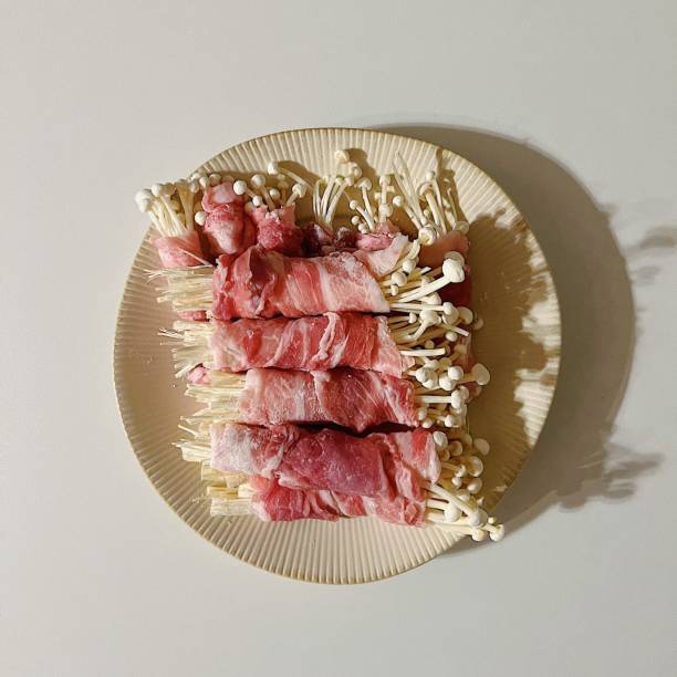 Enoki mushroom rolls, a savory bite of crispy enoki mushrooms wrapped in a delicate roll, offering a delightful mix of textures and flavors in every mouthful.