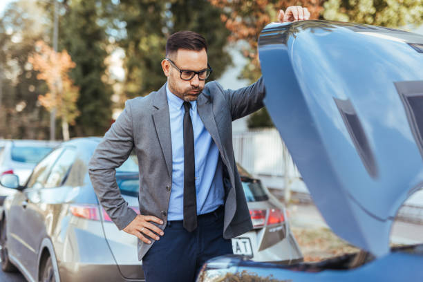 istock Businessman Examining Car Engine Problem on City Street 2185383742