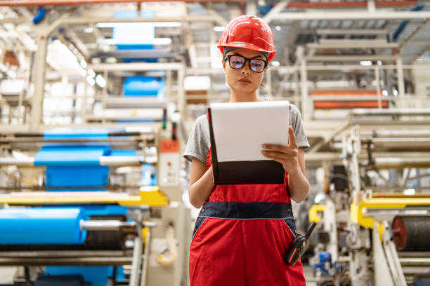 istock Engineer with tablet reviewing process in modern industrial plant with extensive machinery. 2185383892
