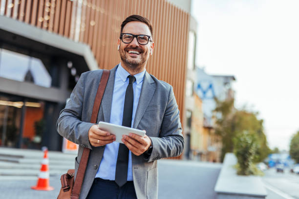 istock Confident Businessman Holding Tablet in Urban Environment 2185384010