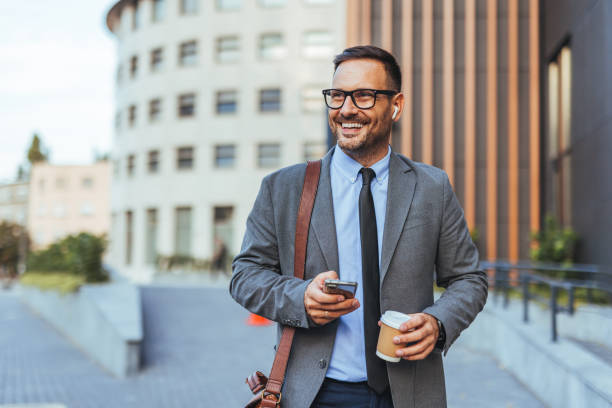 istock Businessman Smiling Outside Modern Office Building With Coffee 2185384086