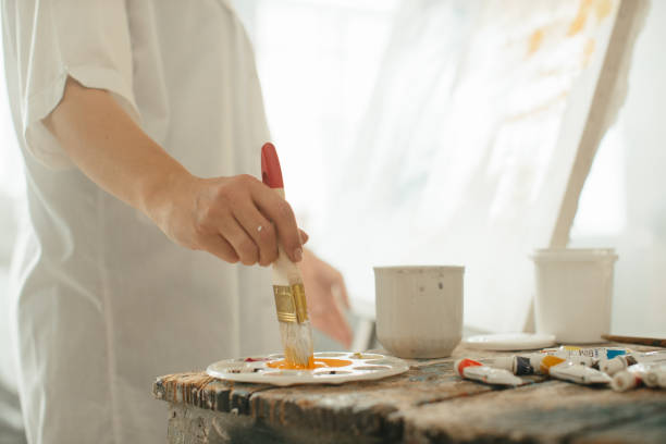 istock Close-up of a female painter working with brushes and paints 2185384349