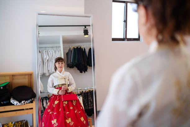 Woman getting dressed with traditional Korean Hanbok