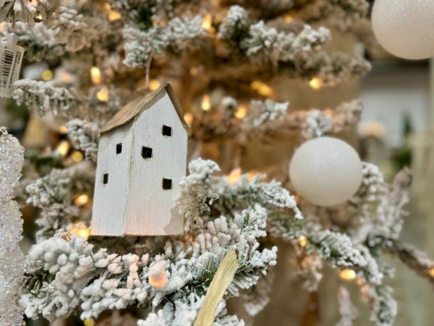 istock White church ornament on white flocked Christmas tree 2185397643