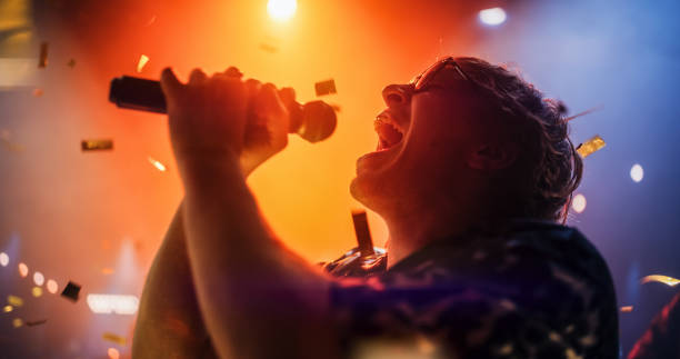 istock Energetic Rock Band Performing on a Nightclub Stage with Dynamic Lights and Special Effects. Portrait of an Artist Creating a Unique Show Experience With Powerful Alternative Songs 2185398701