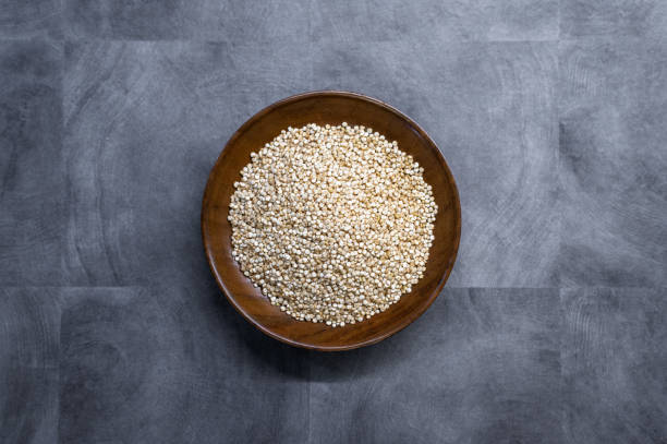 istock Bowl of uncooked quinoa on gray background 2185399105