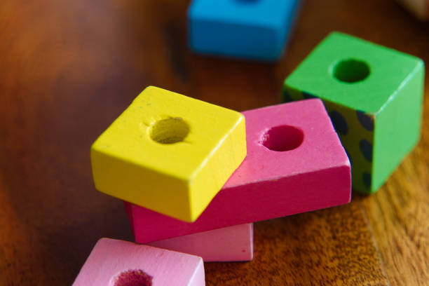 istock Colorful Wooden Toys: A Close-Up of a Child at Play 2185399432