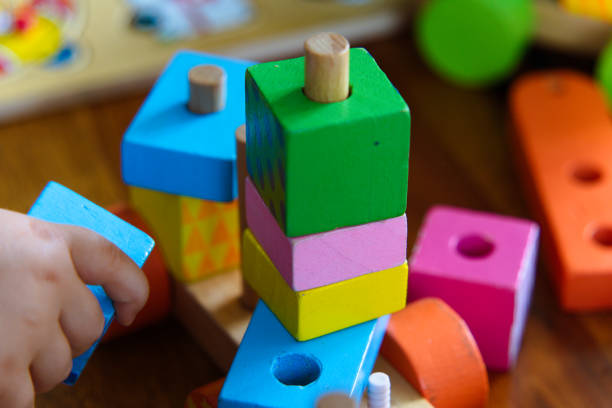 istock Colorful Wooden Toys: A Close-Up of a Child at Play 2185399434