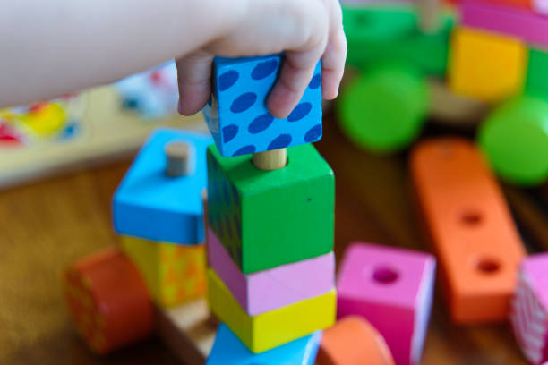 istock Colorful Wooden Toys: A Close-Up of a Child at Play 2185399569