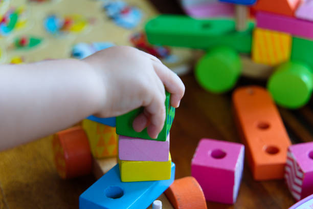 istock Colorful Wooden Toys: A Close-Up of a Child at Play 2185399573