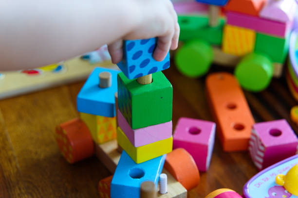 istock Colorful Wooden Toys: A Close-Up of a Child at Play 2185399575