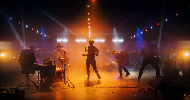 istock Energetic Rock Band Performing on a Nightclub Stage with Dynamic Lights and Special Effects. Rock Music Artists Creating a Unique Show Experience With Powerful Alternative Music 2185400285