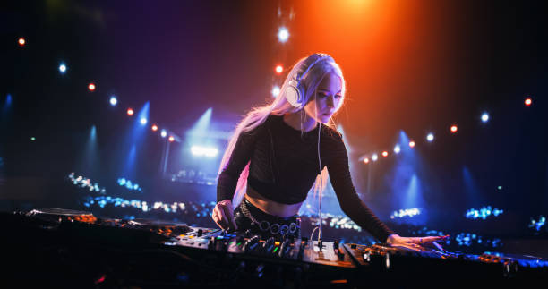 istock Establishing Picture with Professional DJ Equipment on a Club Stage. Mixing Decks, Controllers and Other Gear Standing on a Table, Ready to Be Used by a Popular Music Artist in Front of Audience 2185400929