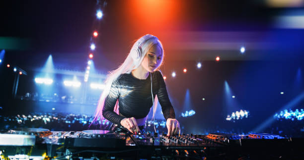 istock Establishing Footage with Professional DJ Equipment on a Club Stage. Mixing Decks, Controllers and Other Gear Standing on a Table, Ready to Be Used by a Popular Music Artist in Front of Audience 2185400966