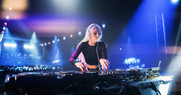 istock Establishing Footage with Professional DJ Equipment on a Club Stage. Mixing Decks, Controllers and Other Gear Standing on a Table, Ready to Be Used by a Popular Music Artist in Front of Audience 2185400988