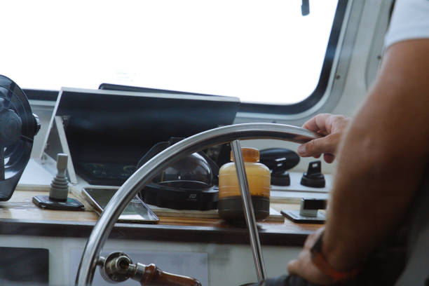 istock Skipper at the Helm: Steering the Boat from the Interior 2185401137