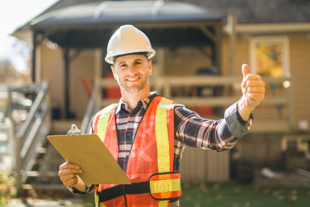 istock man with hard hat standing infront of a house 2185402021