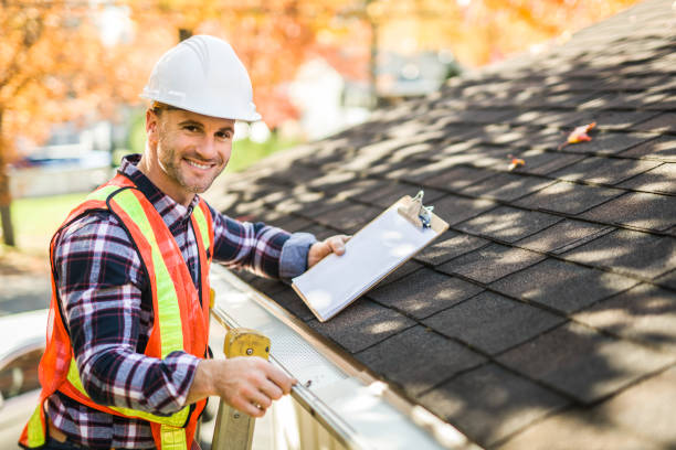 istock man with hard hat standing on steps inspecting house roof 2185402141