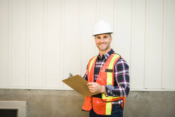 istock Man inspecting house window outside on day light 2185402165