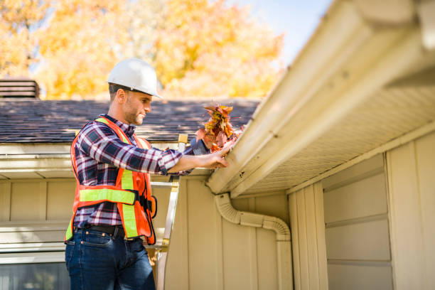 istock man with hard hat standing on steps inspecting house roof 2185402208