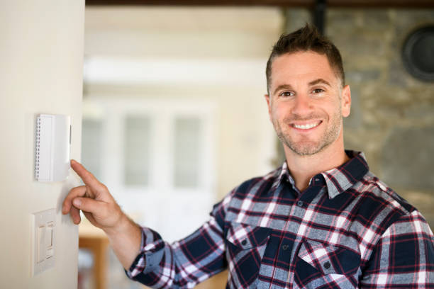 istock A man set the thermostat at house 2185402224