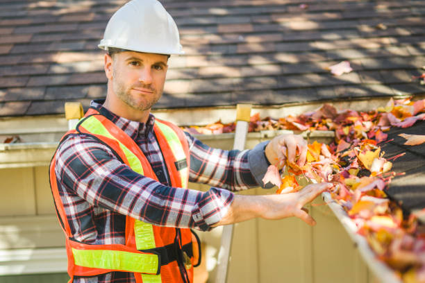 istock man with hard hat standing on steps inspecting house roof 2185402226