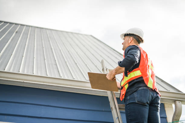 istock man with hard hat standing on steps inspecting house roof 2185402232