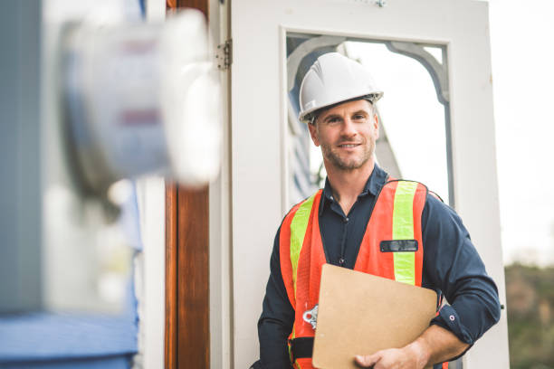 istock man with hard hat standing in front of a electric panel 2185402292