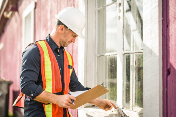 istock Man inspecting house window outside on day light 2185402338