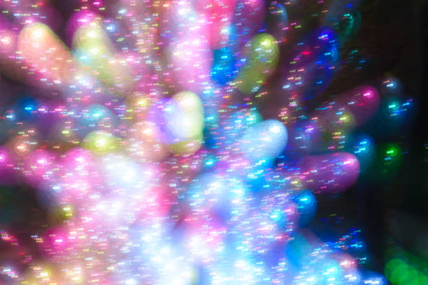 Light painting abstract background. Colorful light balls, long exposure. Abstract butterfly against a black background. Zoom burst effect.